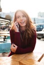 Portrait of a pretty smiling girl talking on mobile phone Royalty Free Stock Photo