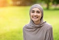 Pretty smiling muslim girl posing in park