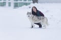 Portrait of Pretty Smiling Woman Hugging Her Husky Dog Outside. Royalty Free Stock Photo