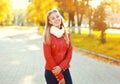 Portrait pretty smiling young woman in sunny autumn