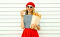 Portrait pretty smiling young woman wearing red beret holding cr Royalty Free Stock Photo