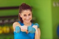 Portrait of pretty sporty girl holding weights Royalty Free Stock Photo