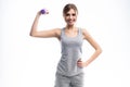 Portrait of pretty sporty girl holding weights dumbbells and make exercises on white background. Royalty Free Stock Photo