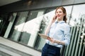 Portrait of pretty student or businesswoman in smart casual using digital tablet Royalty Free Stock Photo