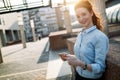 Portrait of pretty student or businesswoman in smart casual using digital tablet Royalty Free Stock Photo