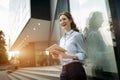 Portrait of pretty student or businesswoman in smart casual using digital tablet Royalty Free Stock Photo