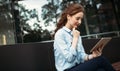 Portrait of pretty student or businesswoman in smart casual using digital tablet Royalty Free Stock Photo