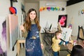 Portrait of a pretty teacher in a art classrom for children