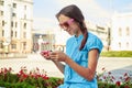 Portrait of pretty teenage girl watching something on her smartp Royalty Free Stock Photo