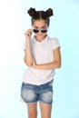 Portrait of a pretty teenage girl 12 years old in a denim shorts with bare legs, she is looking cool Royalty Free Stock Photo