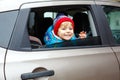 Portrait of pretty toddler boy sitting in car seat. Child transportation safety. Cute healthy kid boy looking happy Royalty Free Stock Photo