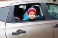 Portrait of pretty toddler boy sitting in car seat. Child transportation safety. Cute healthy kid boy looking happy Royalty Free Stock Photo