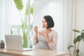 Portrait of pretty Vietnamese woman eating probiotic yogurt Royalty Free Stock Photo