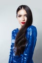 Portrait of pretty woman with long hair and red lips makeup against white wall background Royalty Free Stock Photo