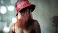 A young girl with red hair in hat