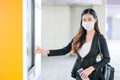 Portrait of pretty woman with mask stand in front of door of sky train on the platform during coronavirus pandemic in city Royalty Free Stock Photo