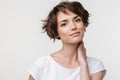 Portrait of pretty woman with short brown hair in basic t-shirt looking at camera Royalty Free Stock Photo