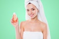 Portrait of pretty woman in towel and turban on head demonstrate lotion shower gel for dry body skin isolated on white Royalty Free Stock Photo