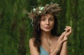 Portrait of pretty woman wearing natural flower laurel wreath outdoor in nature Royalty Free Stock Photo