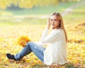 Portrait pretty woman with yellow maple leafs in autumn Royalty Free Stock Photo
