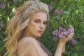 Portrait of a pretty young blonde woman with long curly hair with flowers Royalty Free Stock Photo