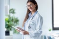 Pretty young female doctor looking at camera while standing in the office Royalty Free Stock Photo