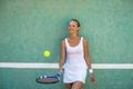 Portrait of a pretty, young, female tennis player in front of a training wall Royalty Free Stock Photo