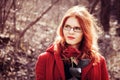 Portrait of pretty young ginger woman in red coat Royalty Free Stock Photo