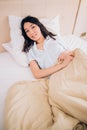 Portrait pretty young girl on bed in modern apartment in the morning Royalty Free Stock Photo