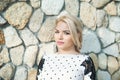 Portrait pretty young girl near stone wall Royalty Free Stock Photo