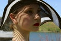 Portrait of pretty young girl wearing a black hat, outdoors, close up. People, travel concept. Royalty Free Stock Photo