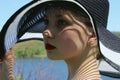Portrait of pretty young girl wearing a black hat, outdoors, close up. People, travel concept. Royalty Free Stock Photo