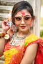 Portrait of pretty young girl wearing traditional Indian saree and jewellery, playing with colours and posing fashionable with Royalty Free Stock Photo