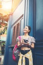 Portrait of pretty young hipster woman having fun in the city with camera taveling Royalty Free Stock Photo