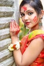 Portrait of pretty young indian girl wearing traditional saree and jewellery, playing with colors. Royalty Free Stock Photo