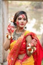 Portrait of pretty young indian girl wearing traditional saree and jewellery, playing with colors Royalty Free Stock Photo