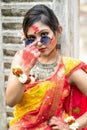 Portrait of pretty young indian girl wearing traditional saree and jewellery, playing with colors and posing fashionable with Royalty Free Stock Photo