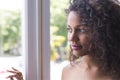 Portrait of pretty young mulatto woman looking at window Royalty Free Stock Photo