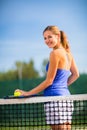 Portrait of a pretty, young tennis player on a court Royalty Free Stock Photo