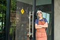 Portrait of pretty young waitress standing arms crossed in cafe. Royalty Free Stock Photo