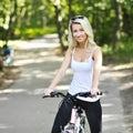 Portrait of pretty young woman with bicycle Royalty Free Stock Photo