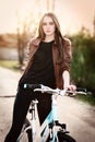 Portrait of pretty young woman with bicycle in a p Royalty Free Stock Photo