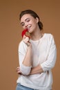 Portrait of pretty young woman biting chili pepper Royalty Free Stock Photo
