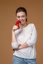 Portrait of pretty young woman biting chili pepper Royalty Free Stock Photo