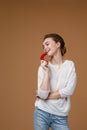 Portrait of pretty young woman biting chili pepper Royalty Free Stock Photo