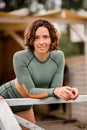 Portrait of pretty young woman with curly hair in nylon swimsuit