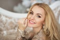 Portrait of pretty young woman in evening dress smiles in Christmas