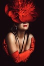 Portrait of pretty young woman with flower hat and red gloves Royalty Free Stock Photo