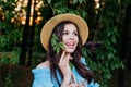 Portrait of pretty young woman standing near leaves outdoors Royalty Free Stock Photo