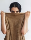 Portrait of a pretty young woman hiding her face under clothes. Attractive Muslim girl hiding face under clothes and looking Royalty Free Stock Photo